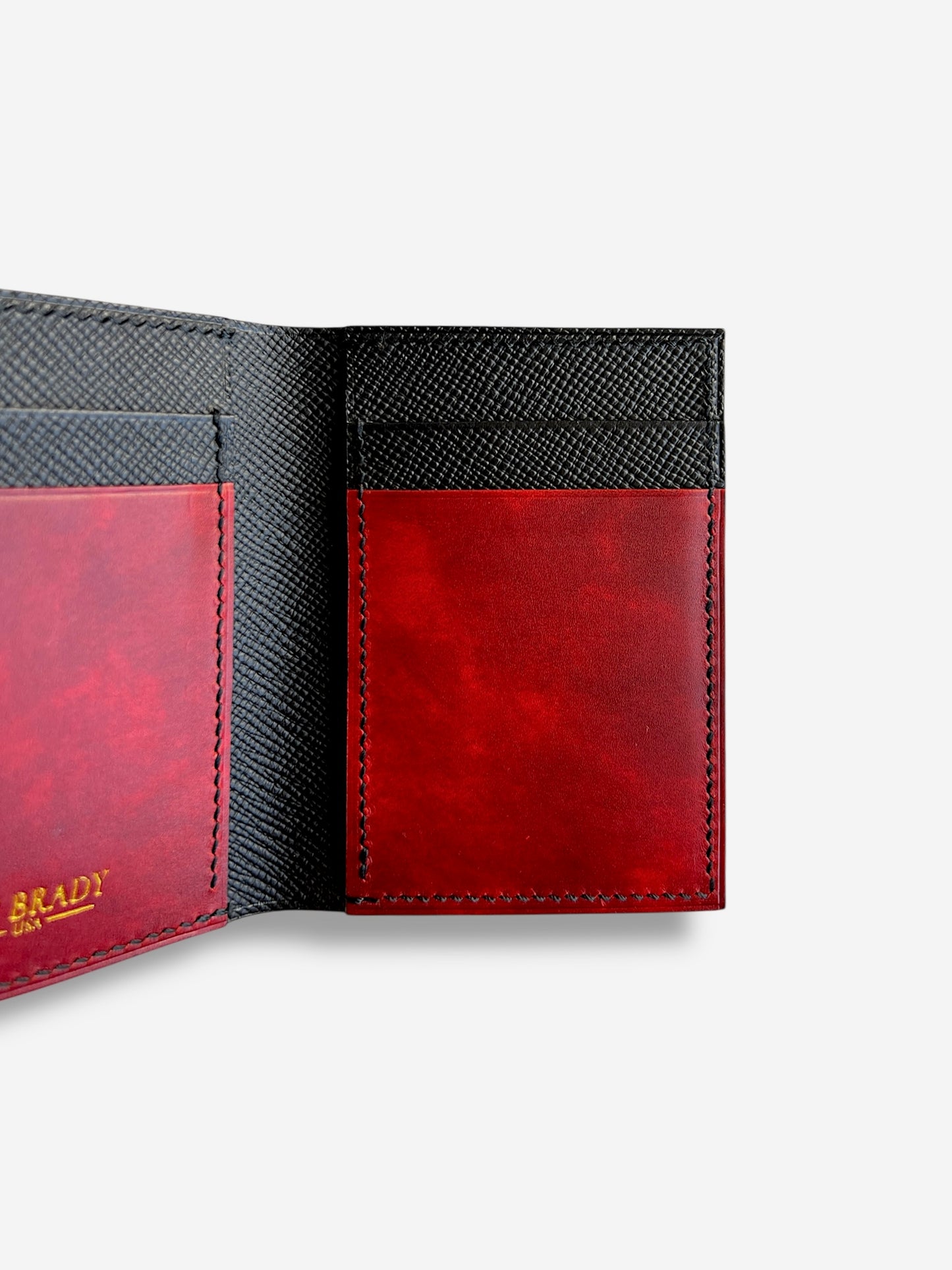 Close-up of a wallet with a red leather patch and visible jon brady usa logo